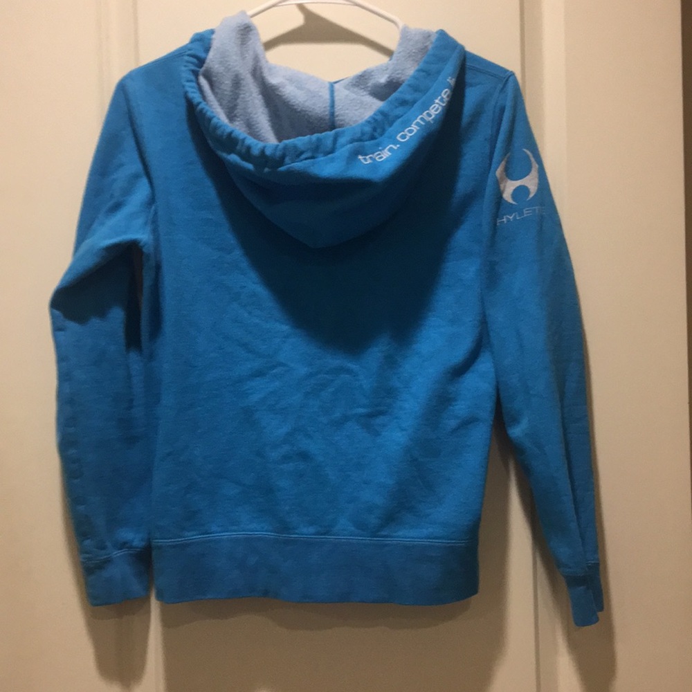 HYLETE womens zip up Hoodie logo sleeve “train.compete.live.”on hood size S blue